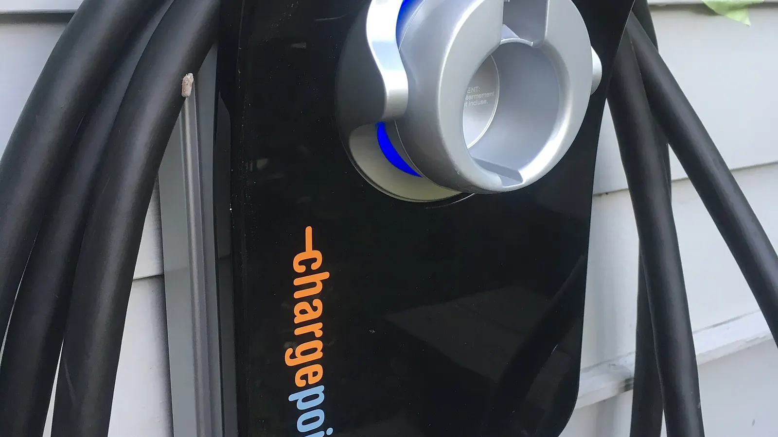 Close-up of a wall-mounted Level 2 home EV charger with the connector docked