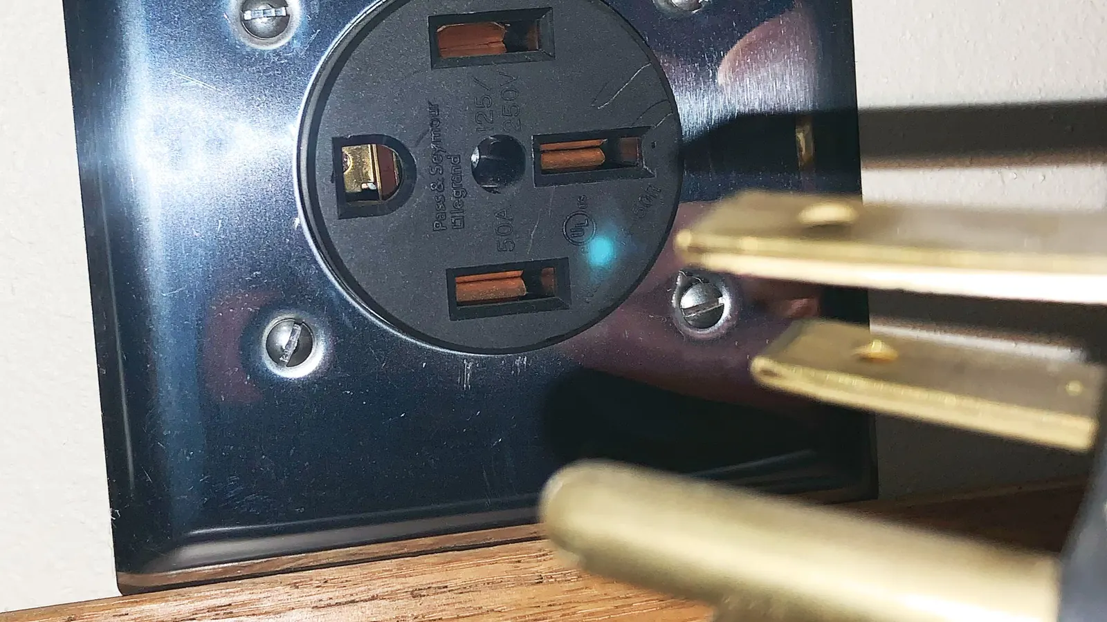 A NEMA 14-50 240-volt receptacle mounted on a wall